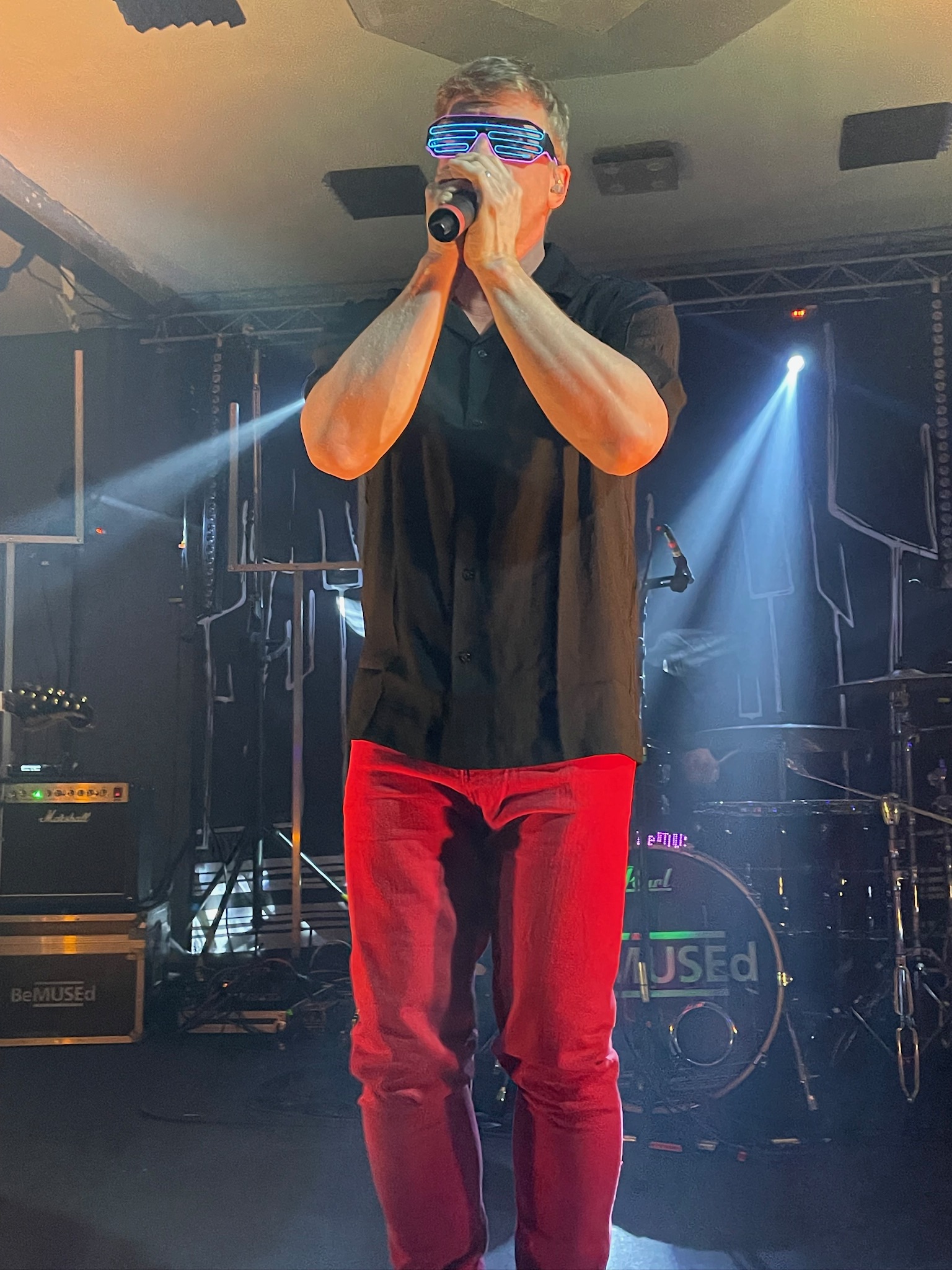 Lead vocalist in signature red pants with LED glasses